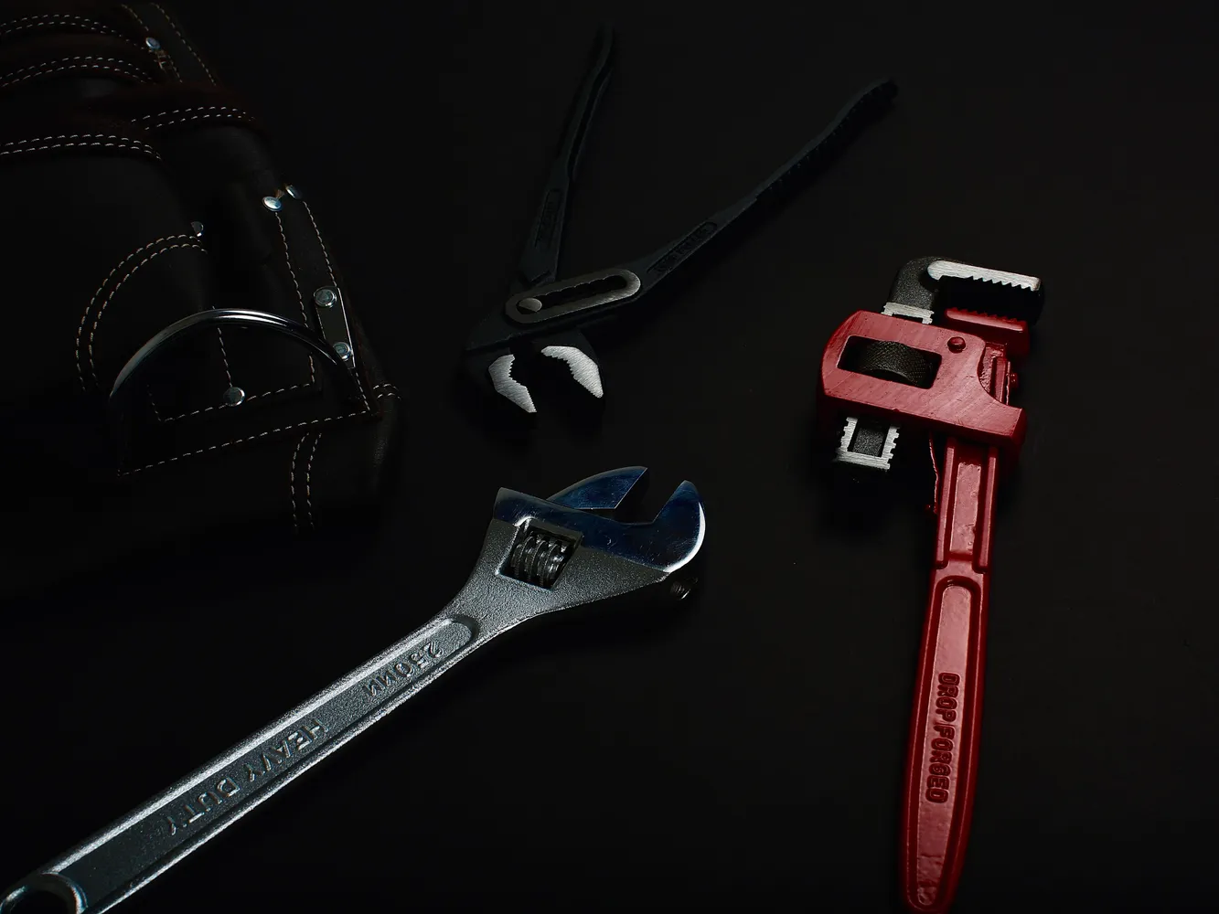 Close up of metallic tools on a dark surface