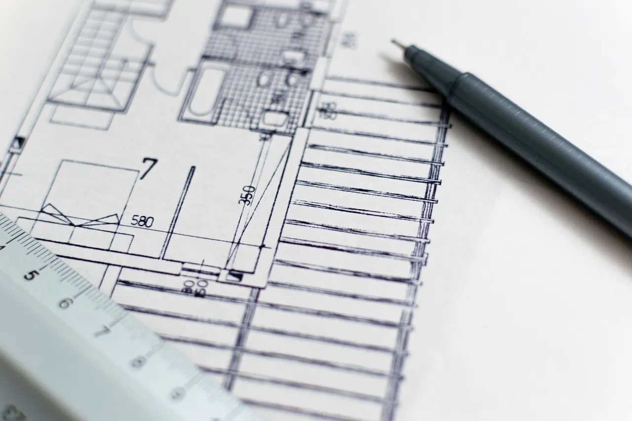 Architectural blueprint and construction site
