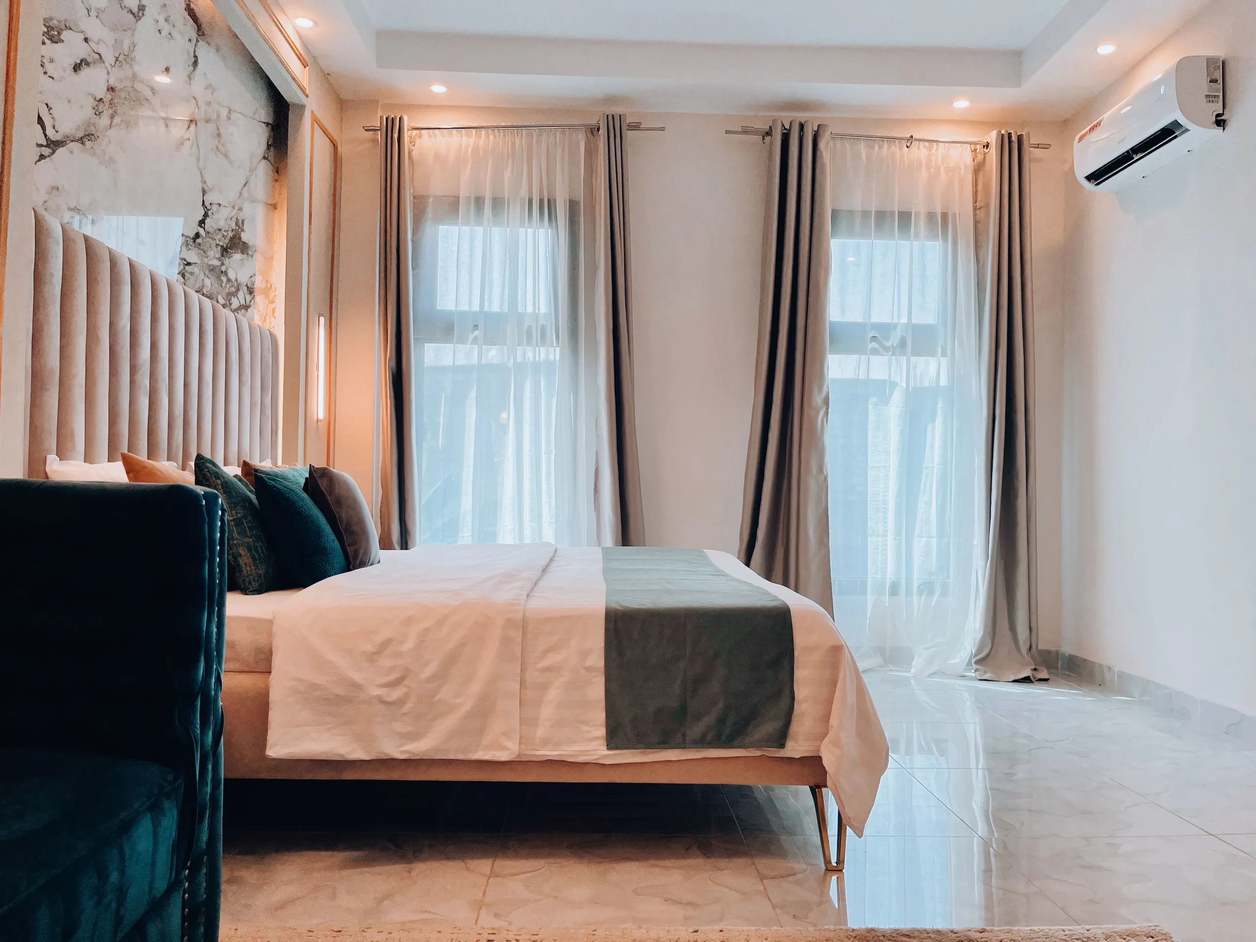 Luxury suite with warm lighting and forest green accents