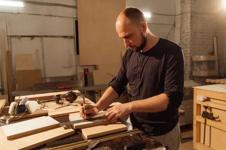 Craftsman measuring wood