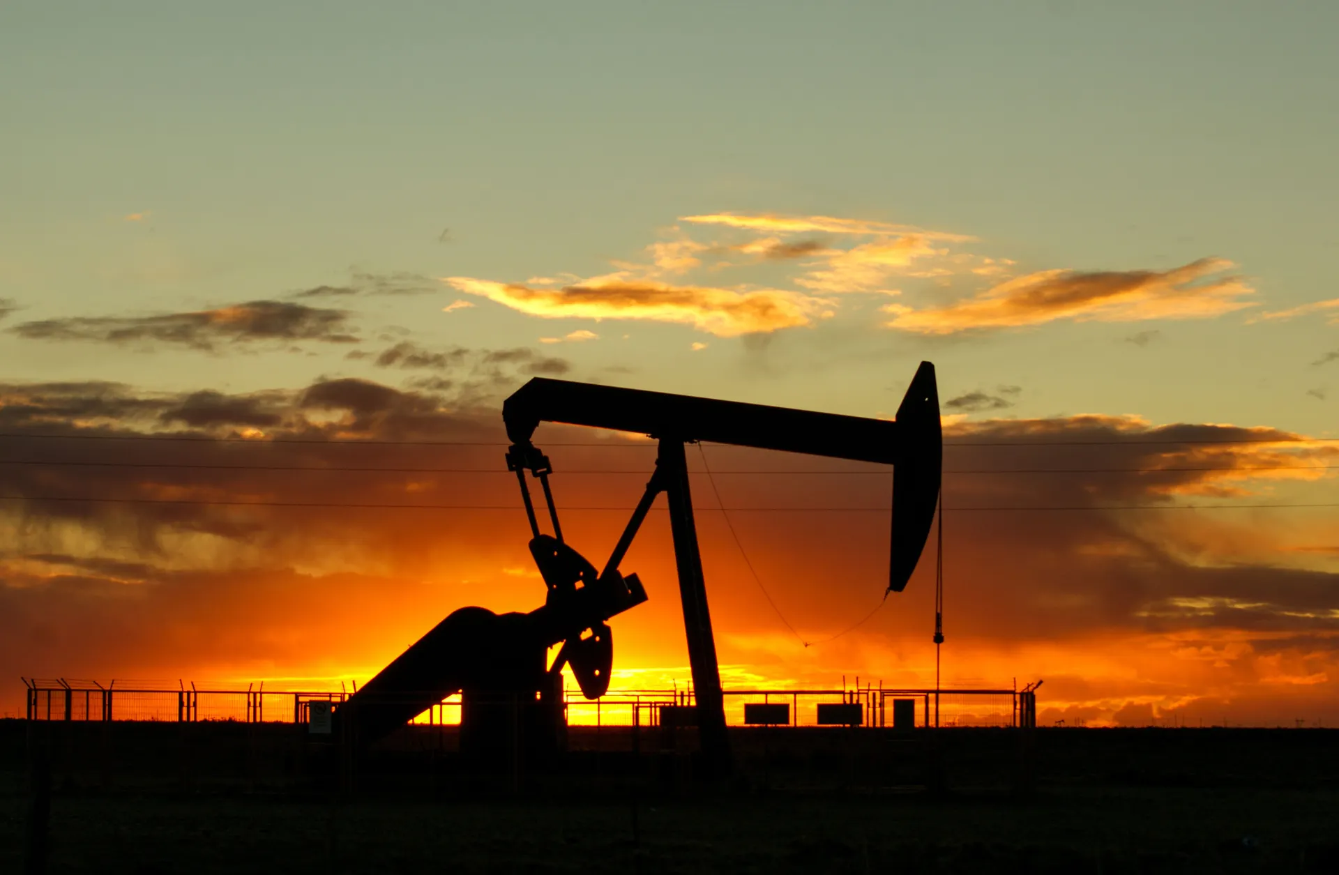 Drilling rig silhouette during sunset
