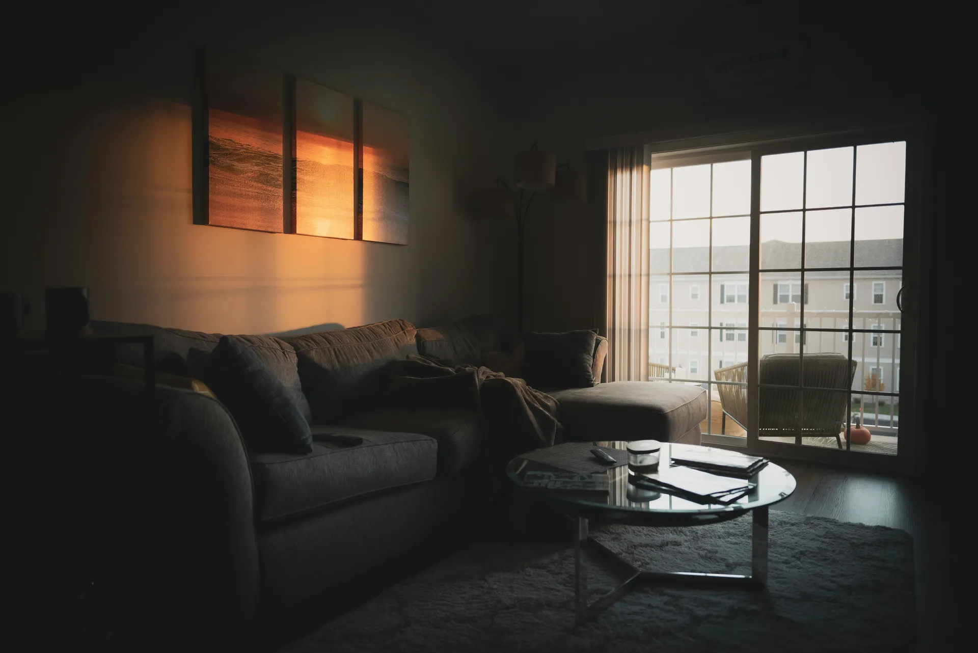 Clean sunlit living room with sectional sofa