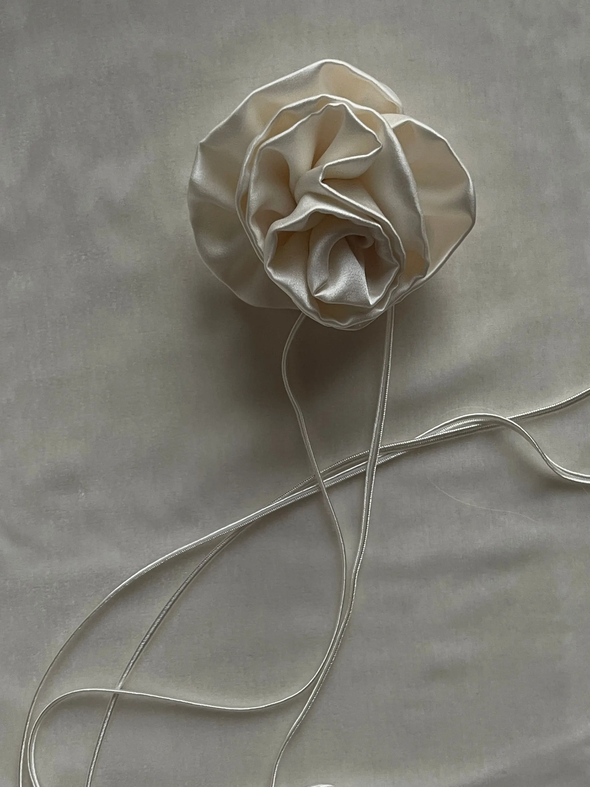 Matte rose gold device resting on silk