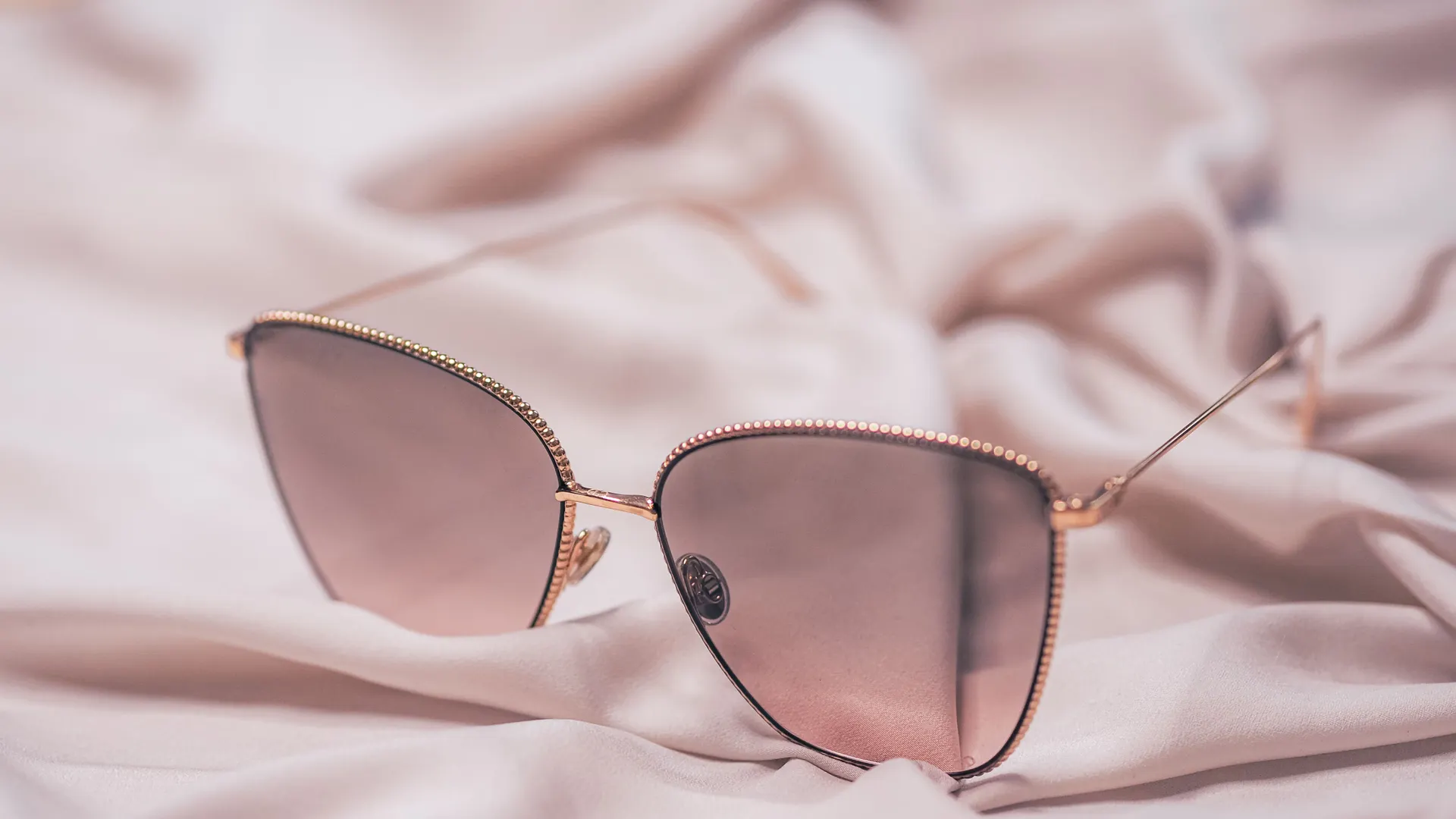 Luxury rose-gold accessory on silk