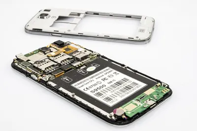 Technician repairing a smartphone circuit board