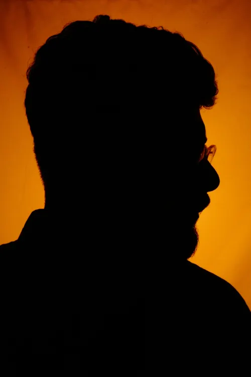 Close up of artist silhouette in amber light