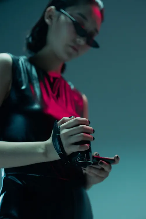 Woman with camcorder in moody blue light