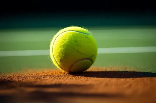 Tennis ball on clay court