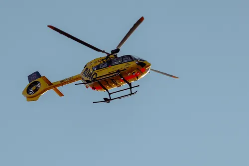 Yellow rescue helicopter in flight