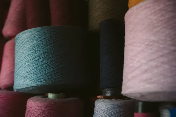 Close-up texture of cream silk and navy wool fibers