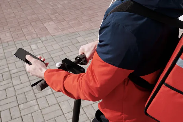Delivery person using smartphone for navigation