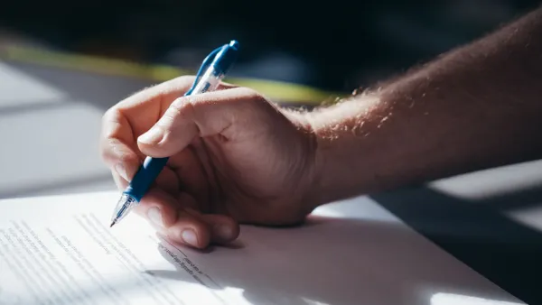 Hand signing a safety document