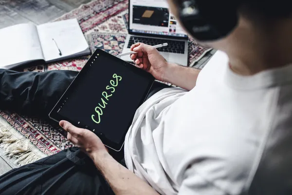 Student studying forex trading on a tablet with professional focus
