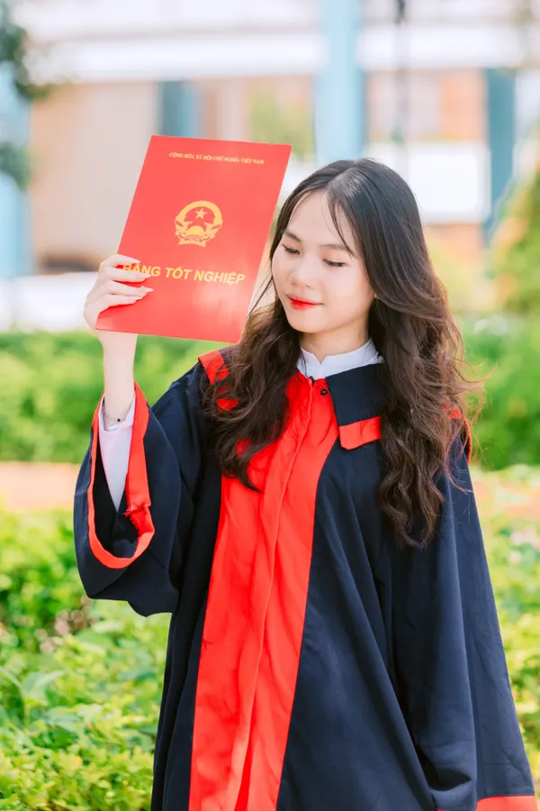 A successful graduate from the Class of 2024 holding her technical certificate outdoors