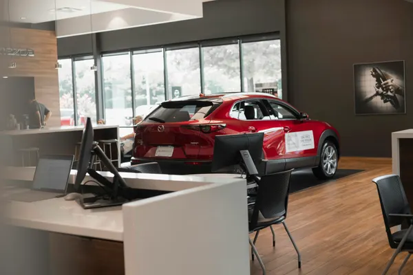 Busy car showroom representing momentum