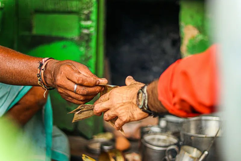 Person handing currency to another person