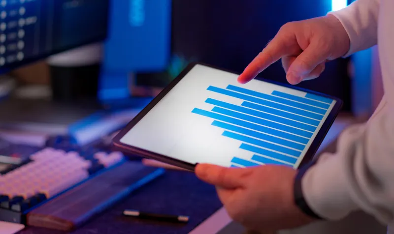 Professional analyzing data on a tablet