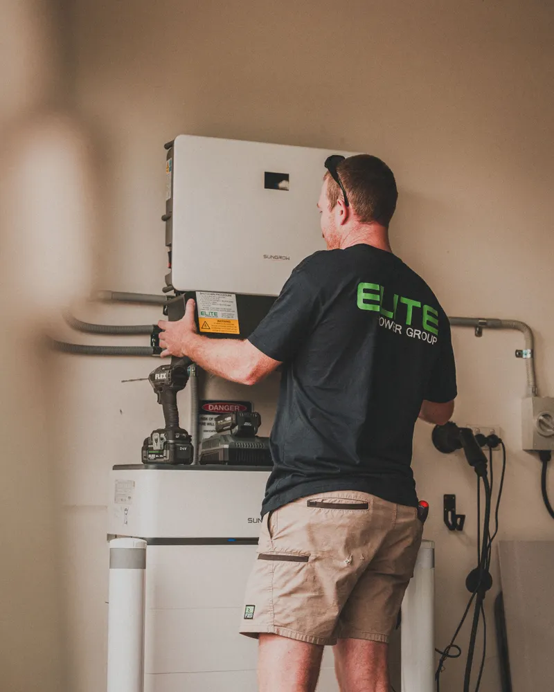 Expert technician installing solar battery