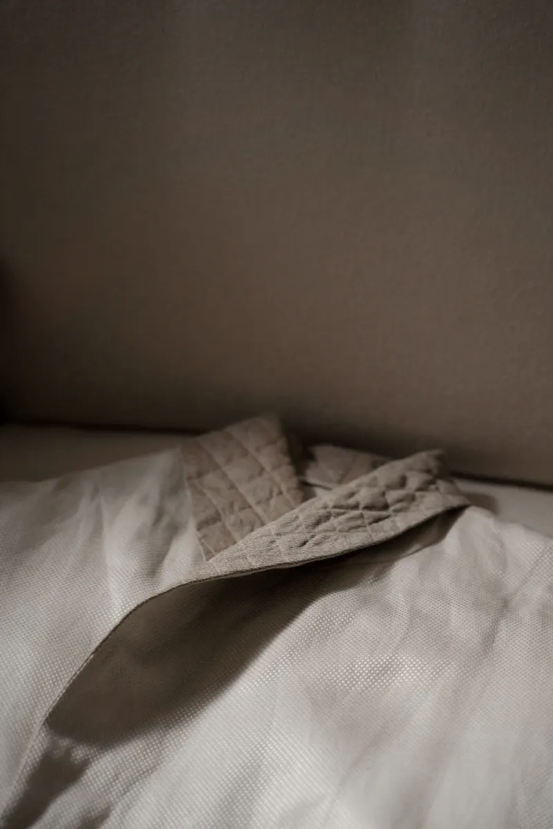 Minimalist wand on linen sheets