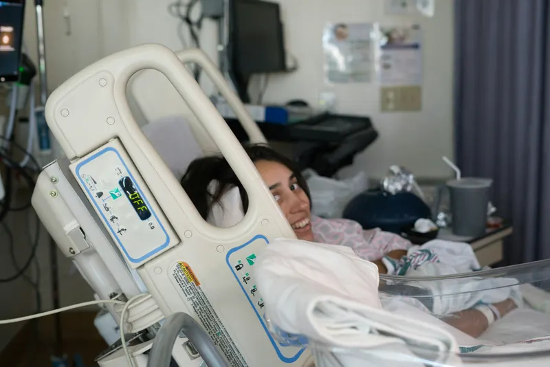Smiling patient in a clean maternity ward interior
