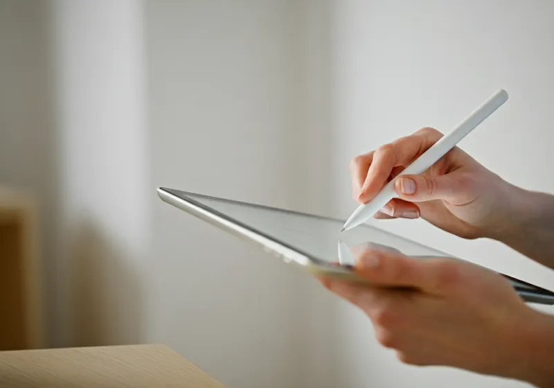 Adult learner using a tablet with a mentor