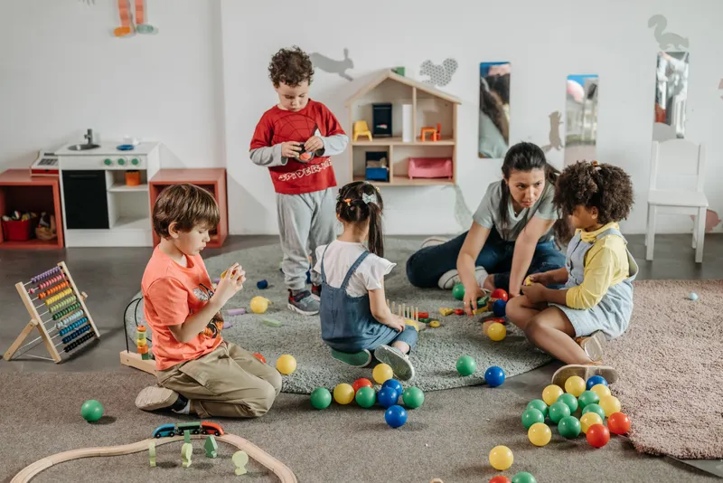 Children and teacher engaging in preschool play