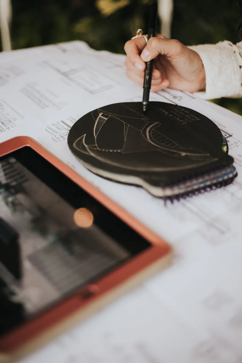 Technical plans on a desk with digital tablet