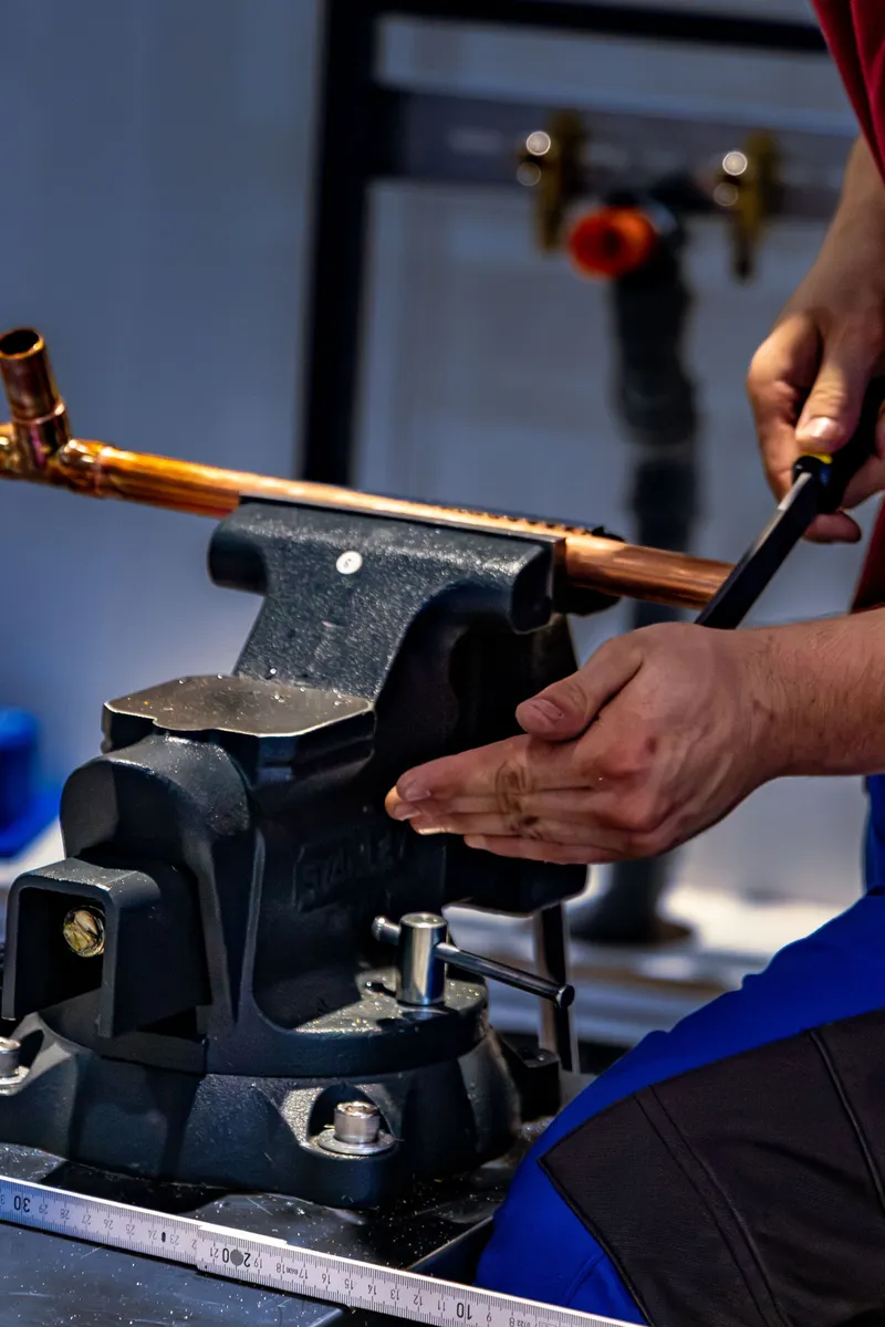 Plumber working with copper pipe precision
