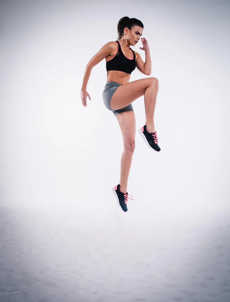 Female athlete performing explosive jump exercise